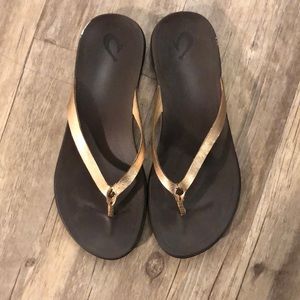 Olukai gold flip flops